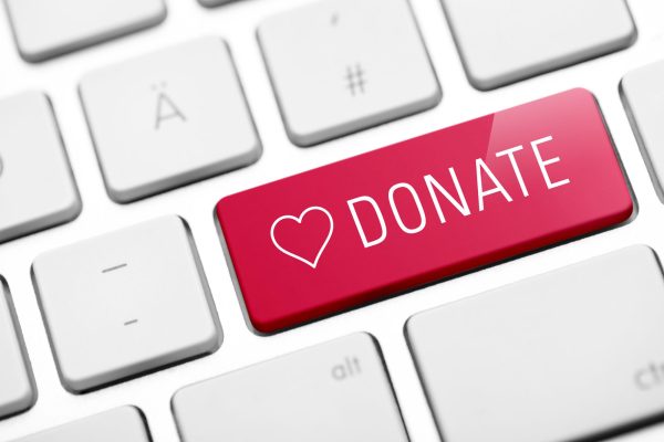 Red donate button with a heart on a keyboard